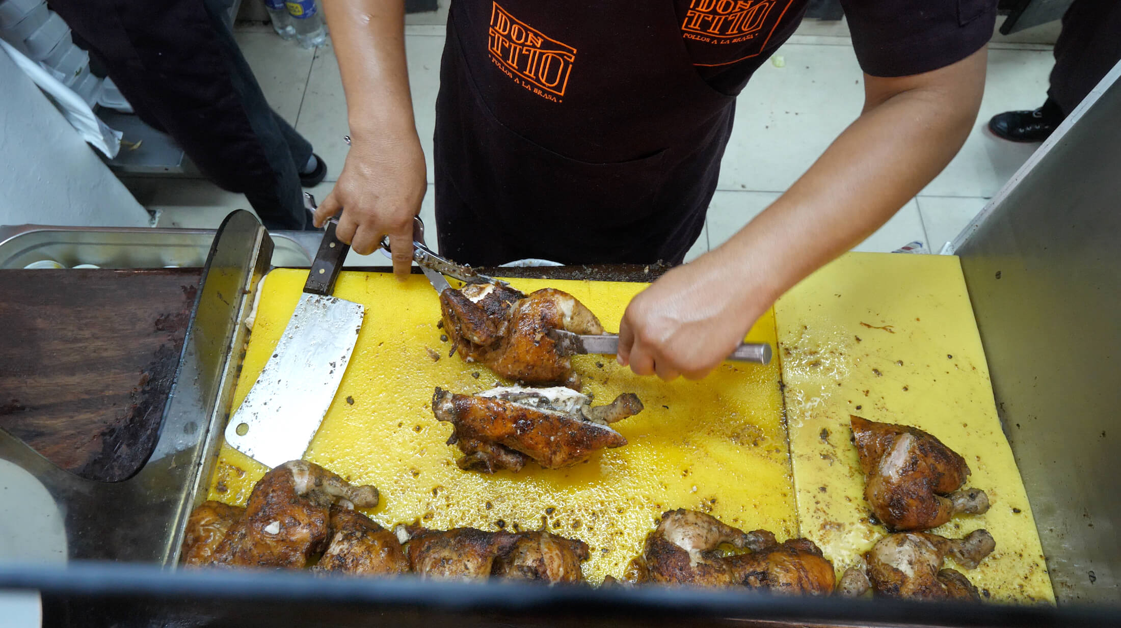 Watching staff prepare a whole chicken at Don Tito's