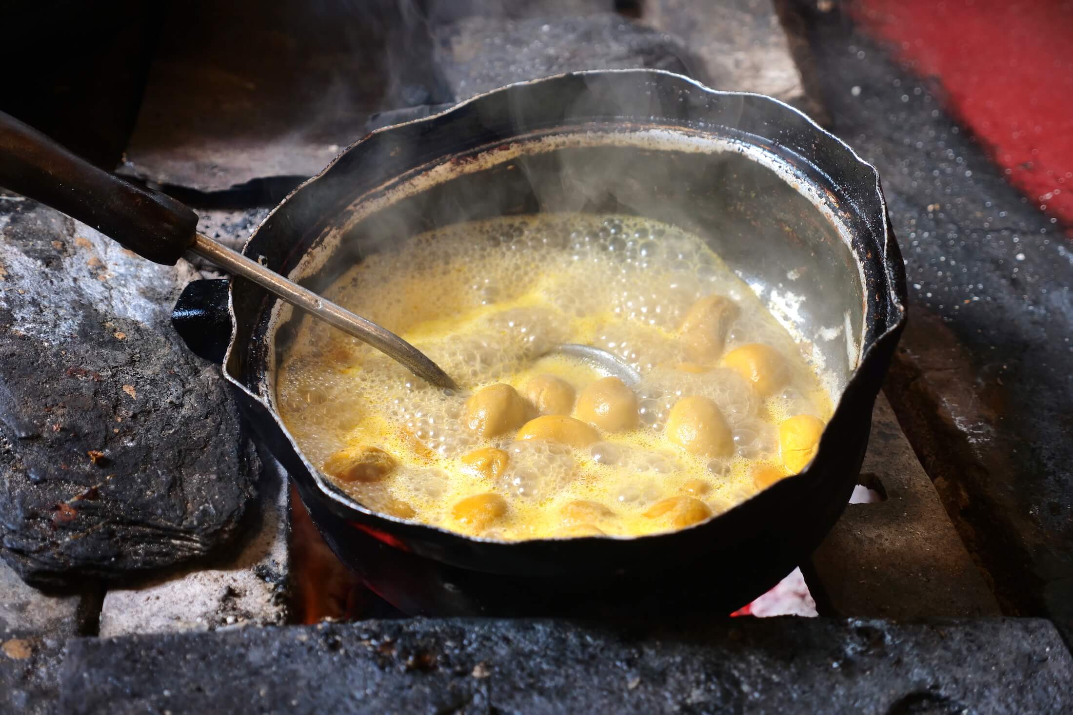 pequi fruit frying in just oil and its own moisture