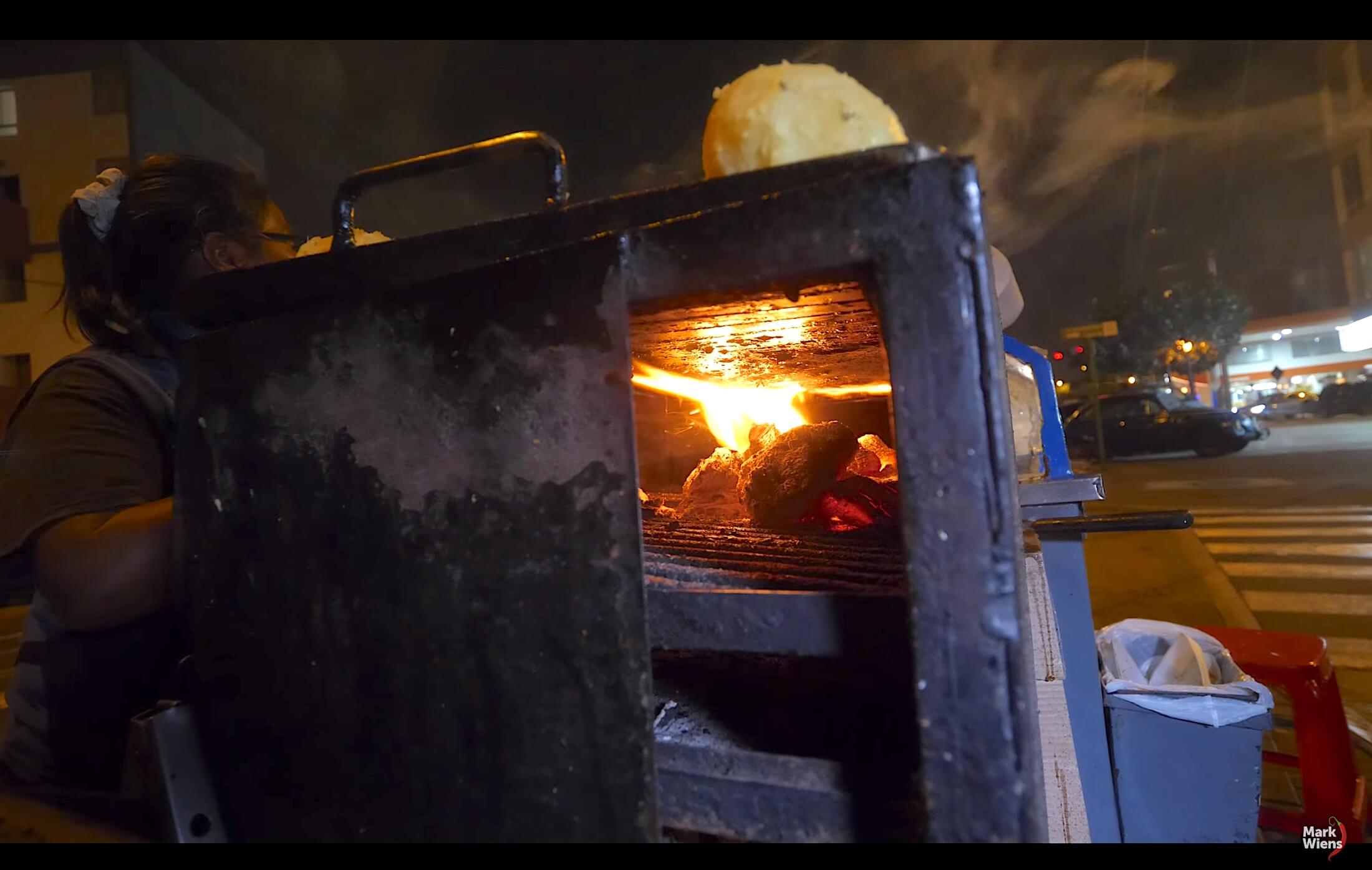 A workman's toolbox grill device, with the inside trays full of fire instead