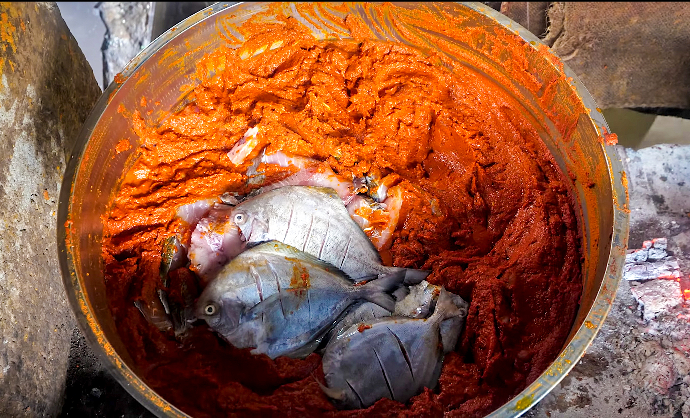 Each fish enters this massive mother pot full of Kerala-style curry paste