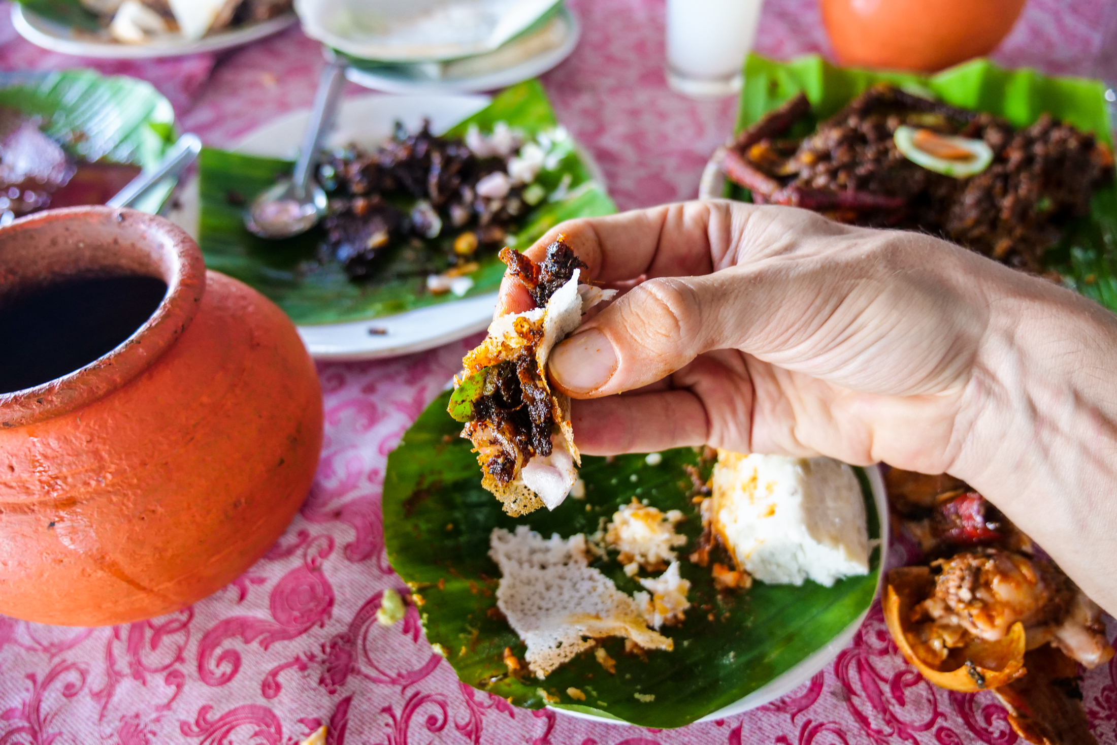 Eating with hands during meals at a Kerala Toddy Shop, is the traditional way with both Appam, and Cassava.